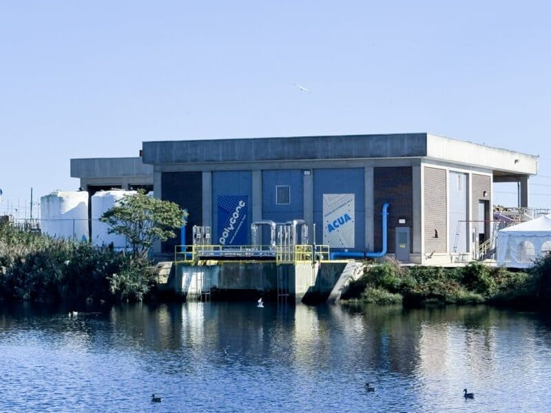 Atlantic County Utilities Authority (ACUA) wastewater treatment facility in Atlantic City, NJ, featuring PolyGone microplastic filtration equipment beside a coastal waterway.