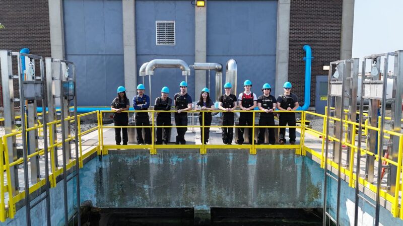 PolyGone team wearing blue hard hats at the ACUA wastewater treatment facility in Atlantic City, NJ, showcasing microplastic removal technology.